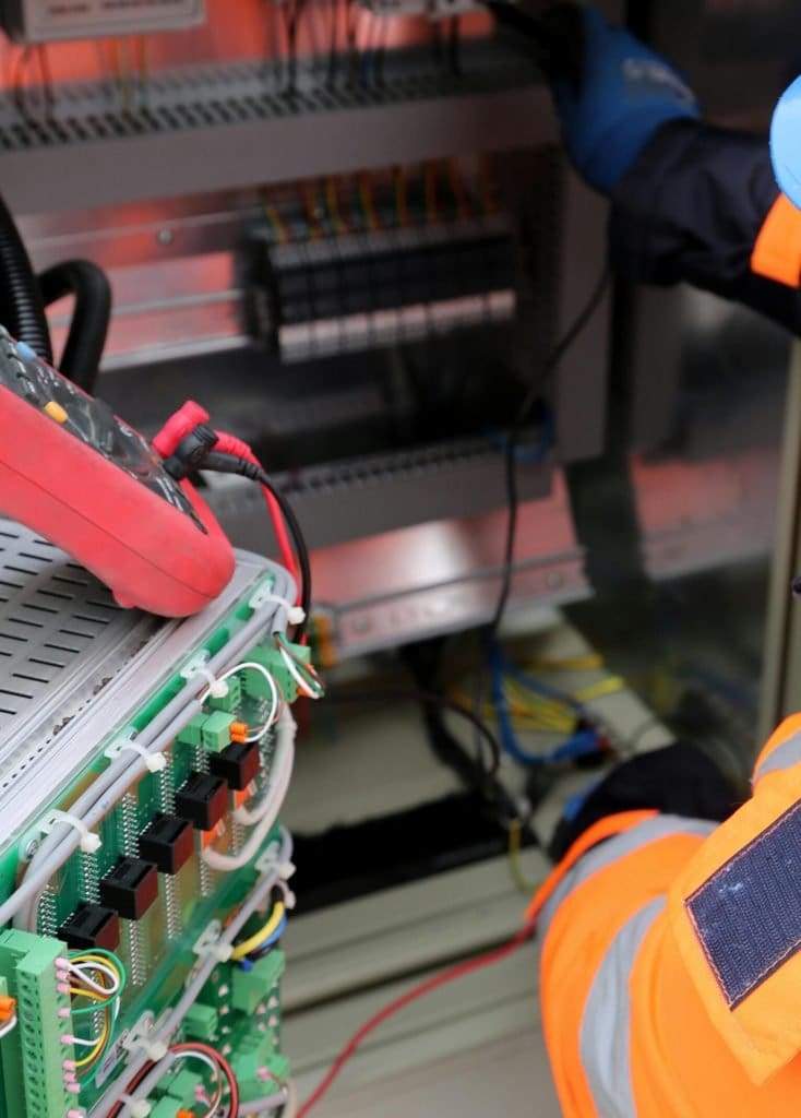 Man in Hard Hat and Eyeglasses Working with Electric Equipment